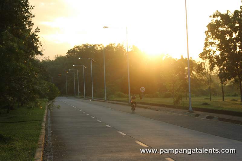 Biker on Road at Sunset
