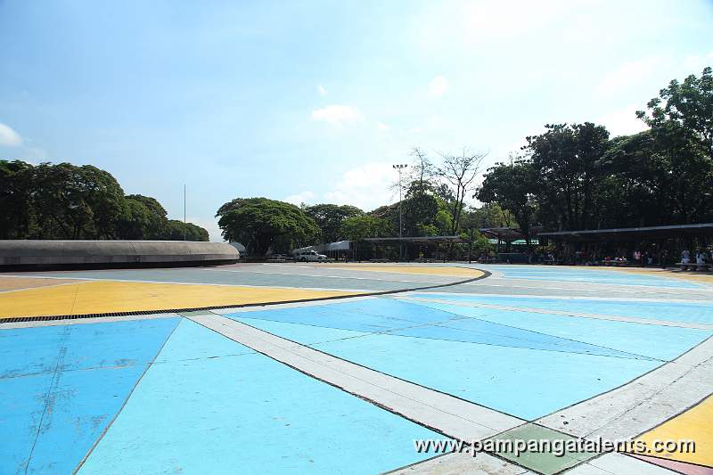 Quezon Memorial Circle in the morning with Park goers on the rightside doing their aerobics.